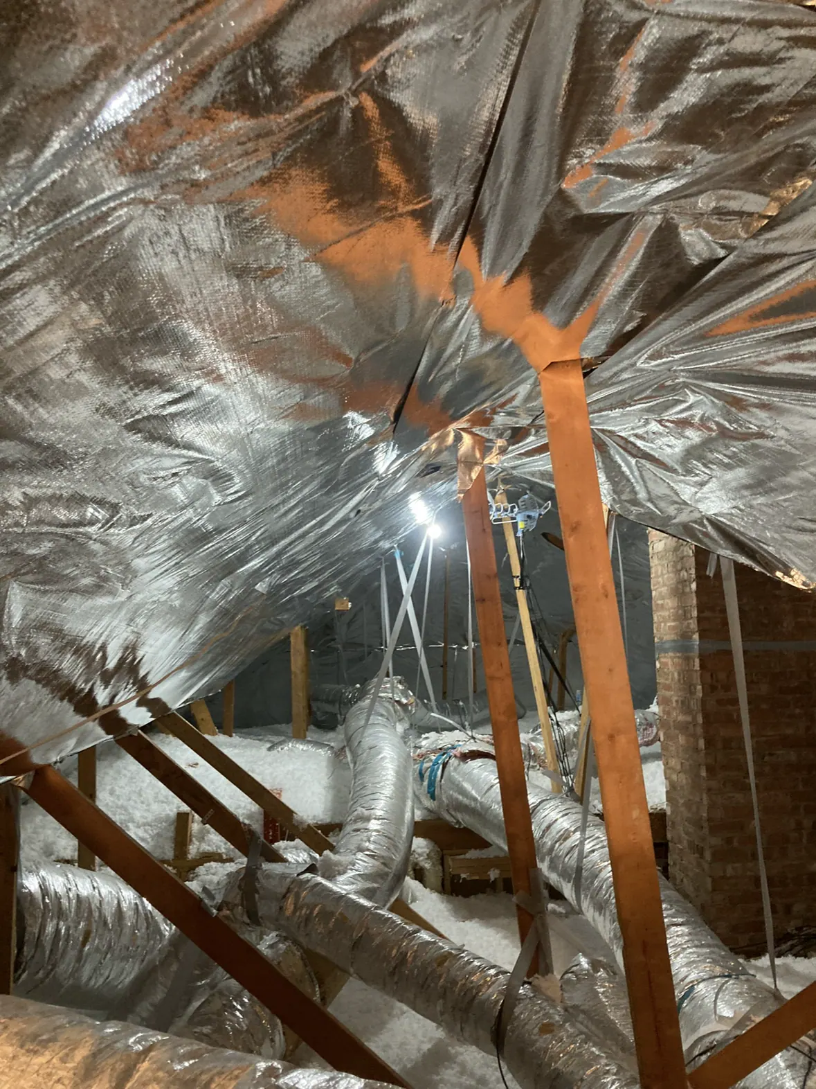 Existing attic assembly with insulation, roof sheathing, and ductwork