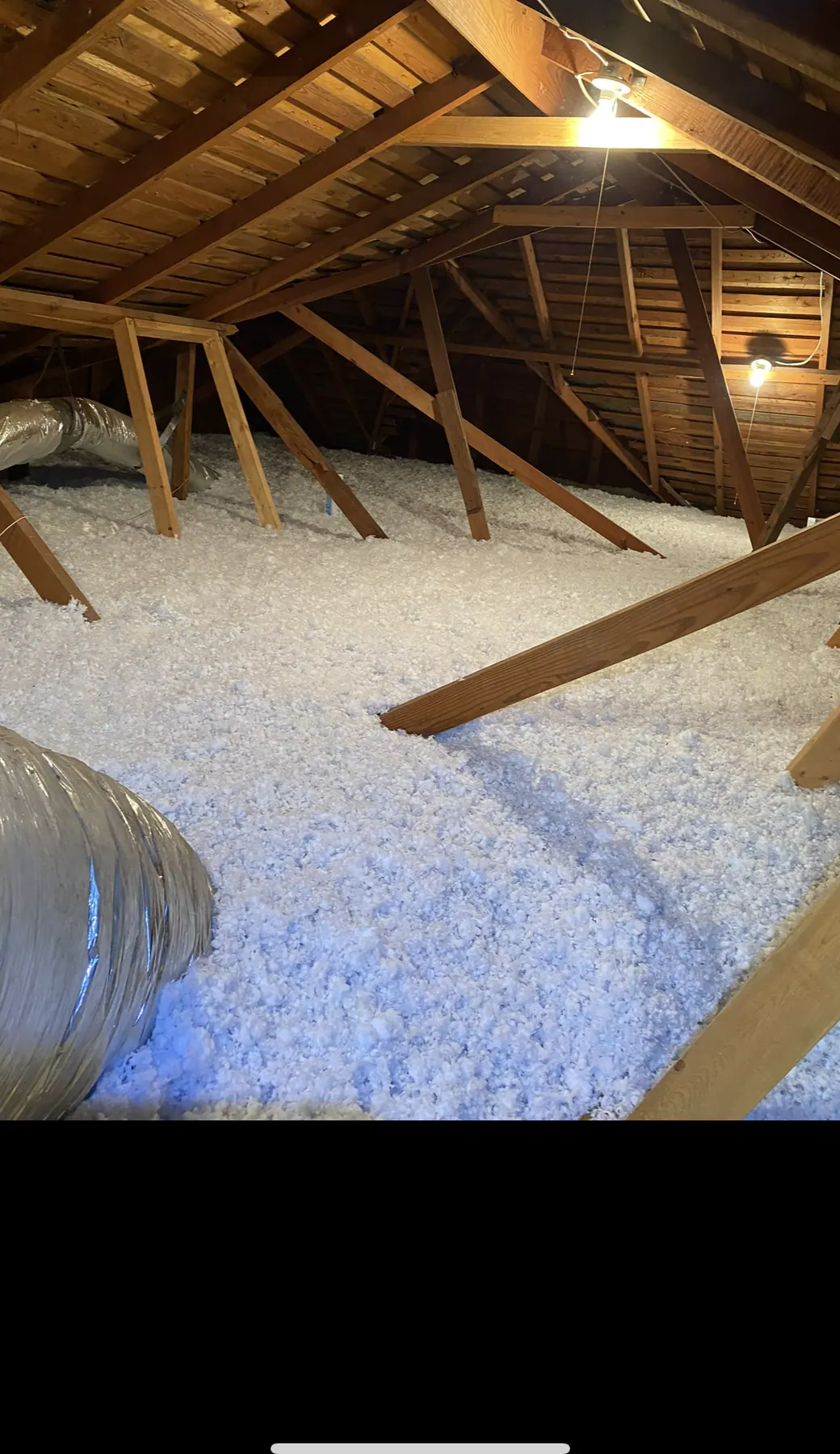 Completed blown-in fiberglass insulation across a residential attic