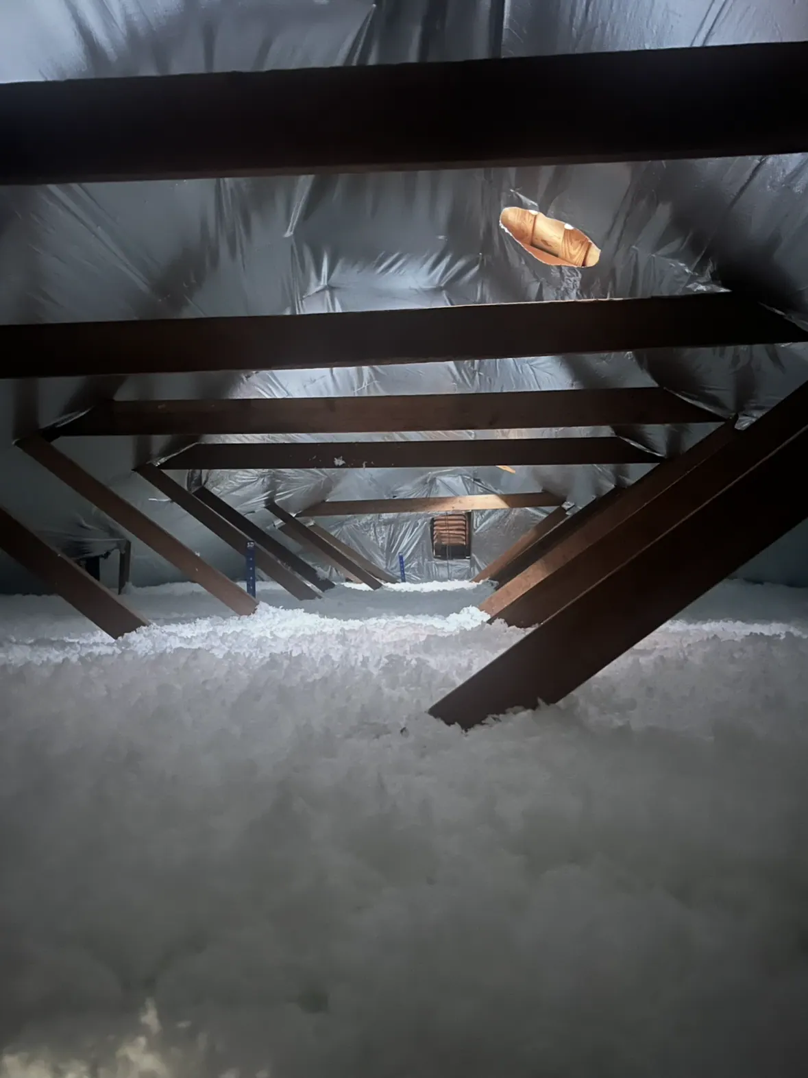 Completed loose-fill insulation coverage beneath a residential roof assembly