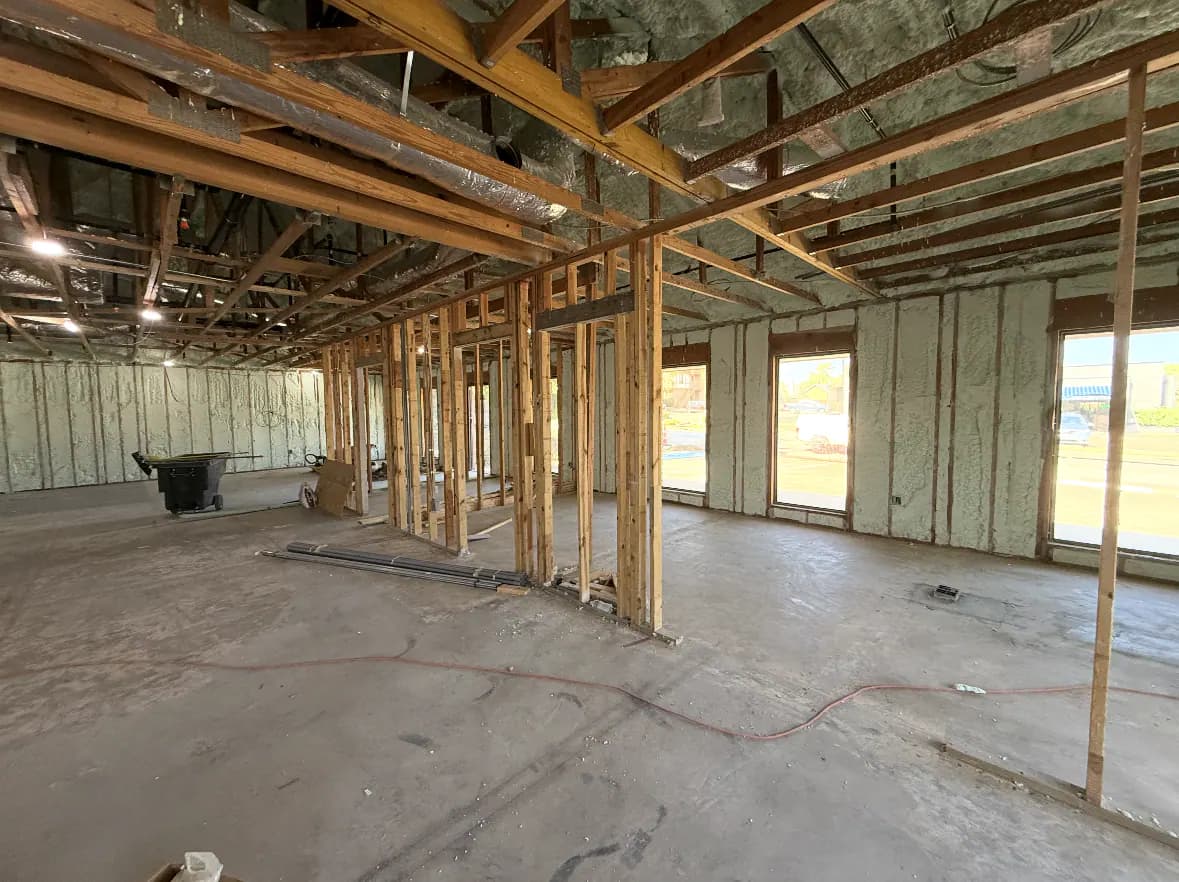 Wide new-construction framing view with completed spray foam wall coverage