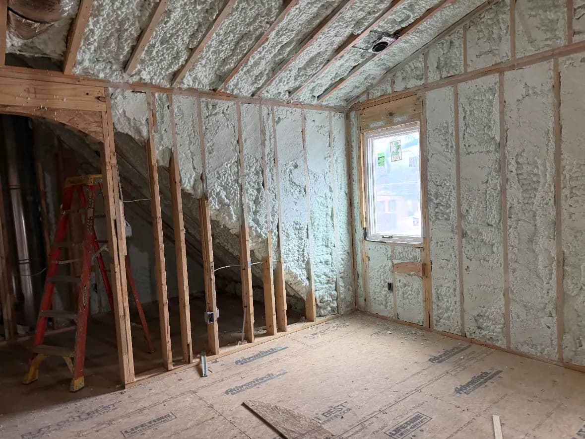 Open-cell spray foam installed in new-construction wall and roof cavities