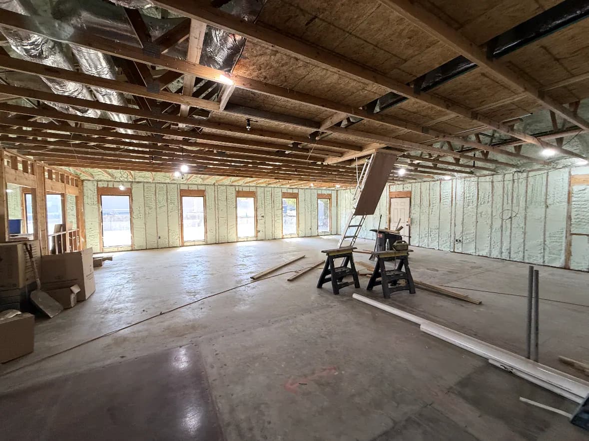 Wide view of spray foam wall insulation in a residential new-construction project